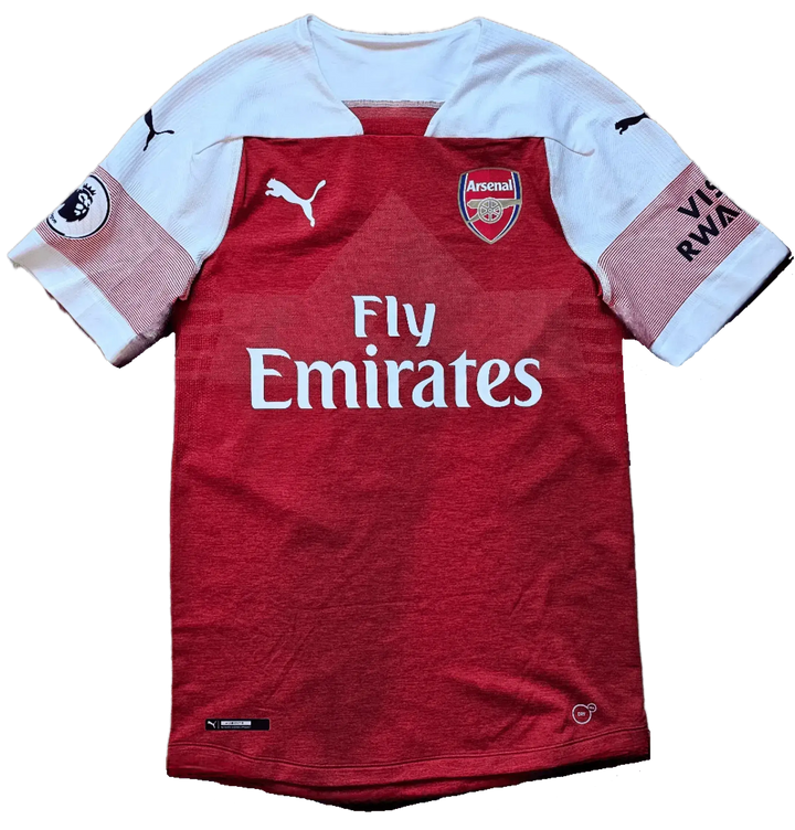 Front view showing Arsenal crest, Fly Emirates sponsor, and Puma logo on a red soccer jersey.
