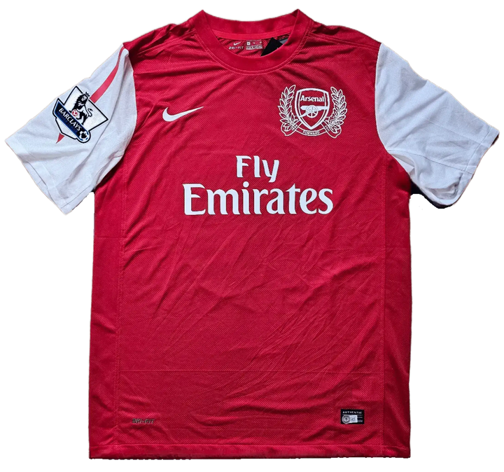 Front view of Arsenal football shirt with Fly Emirates logo and Arsenal crest.