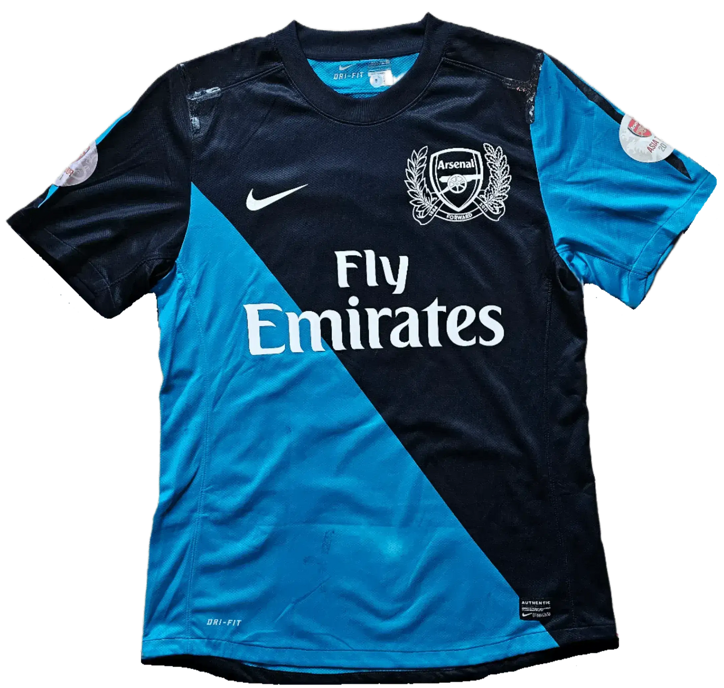Back view of blue and navy Arsenal F.C. soccer jersey with Fly Emirates sponsor.
