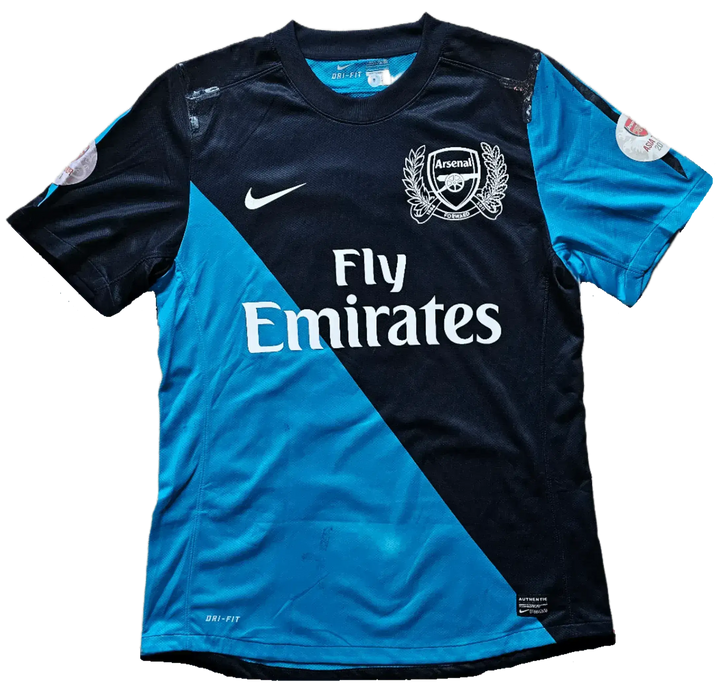 Back view of blue and navy Arsenal F.C. soccer jersey with Fly Emirates sponsor.