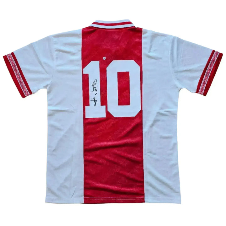 Back view showing No. 10 and signature on a red and white football shirt.