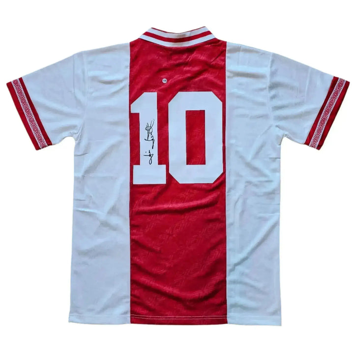 Back view featuring No. 10 and visible signature on a red and white football shirt.