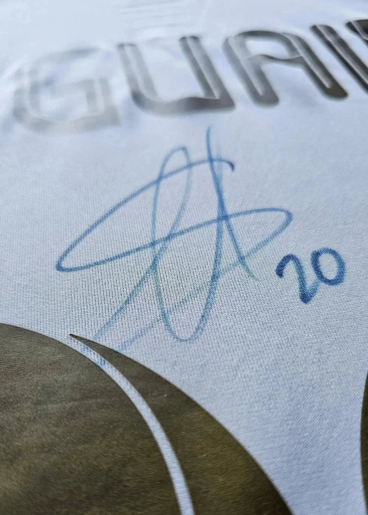 Signature detail showing Gonzalo Higuaín's signature and No. 20 on a white football shirt.