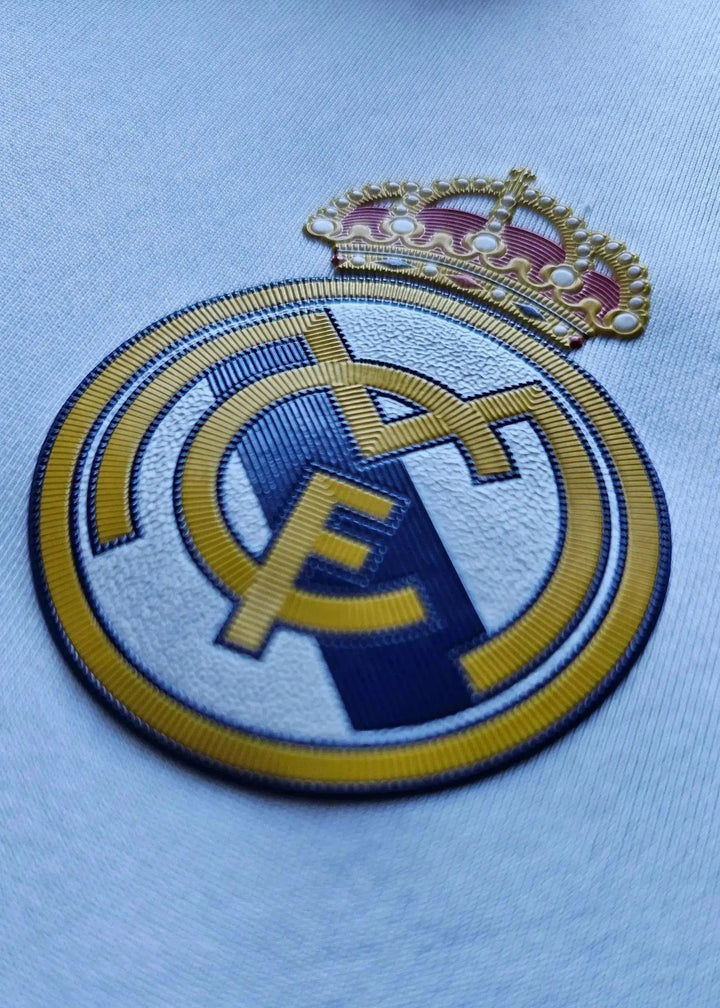 Crest detail of Real Madrid CF, featuring the emblem with crown and blue accents.