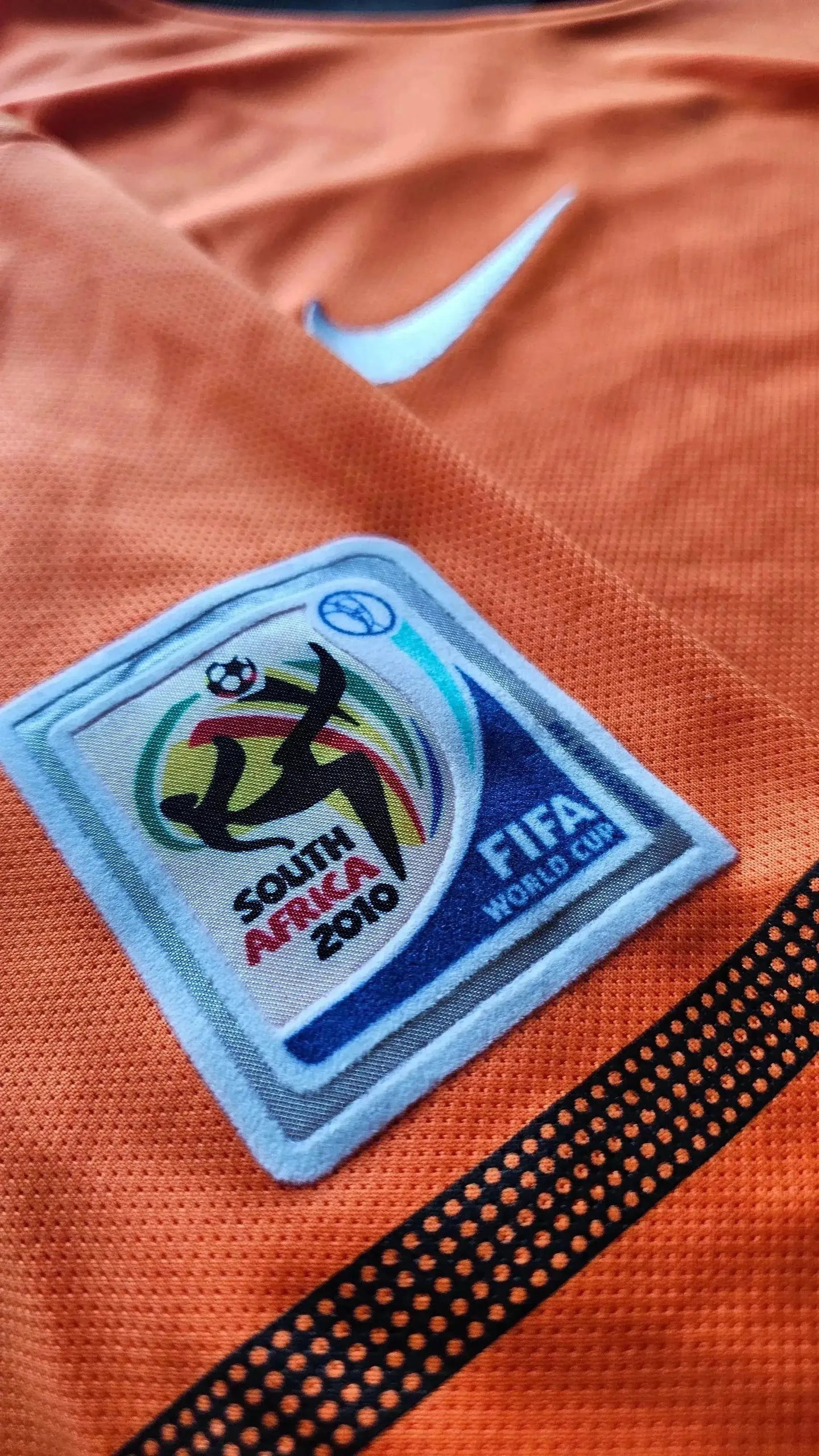 Close-up of Holland Football Shirt showing FIFA World Cup badge and Nike logo in orange.