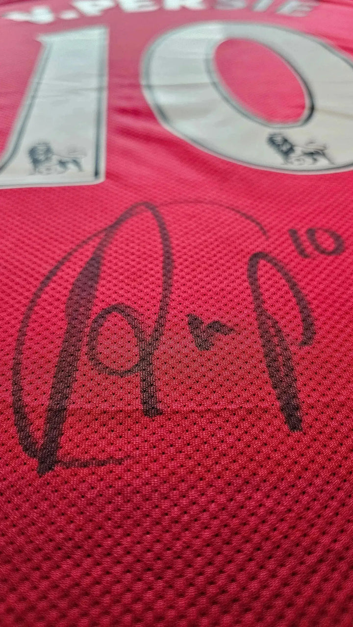 Close-up of signature on red Arsenal F.C. football shirt with No. 10 for van Persie.
