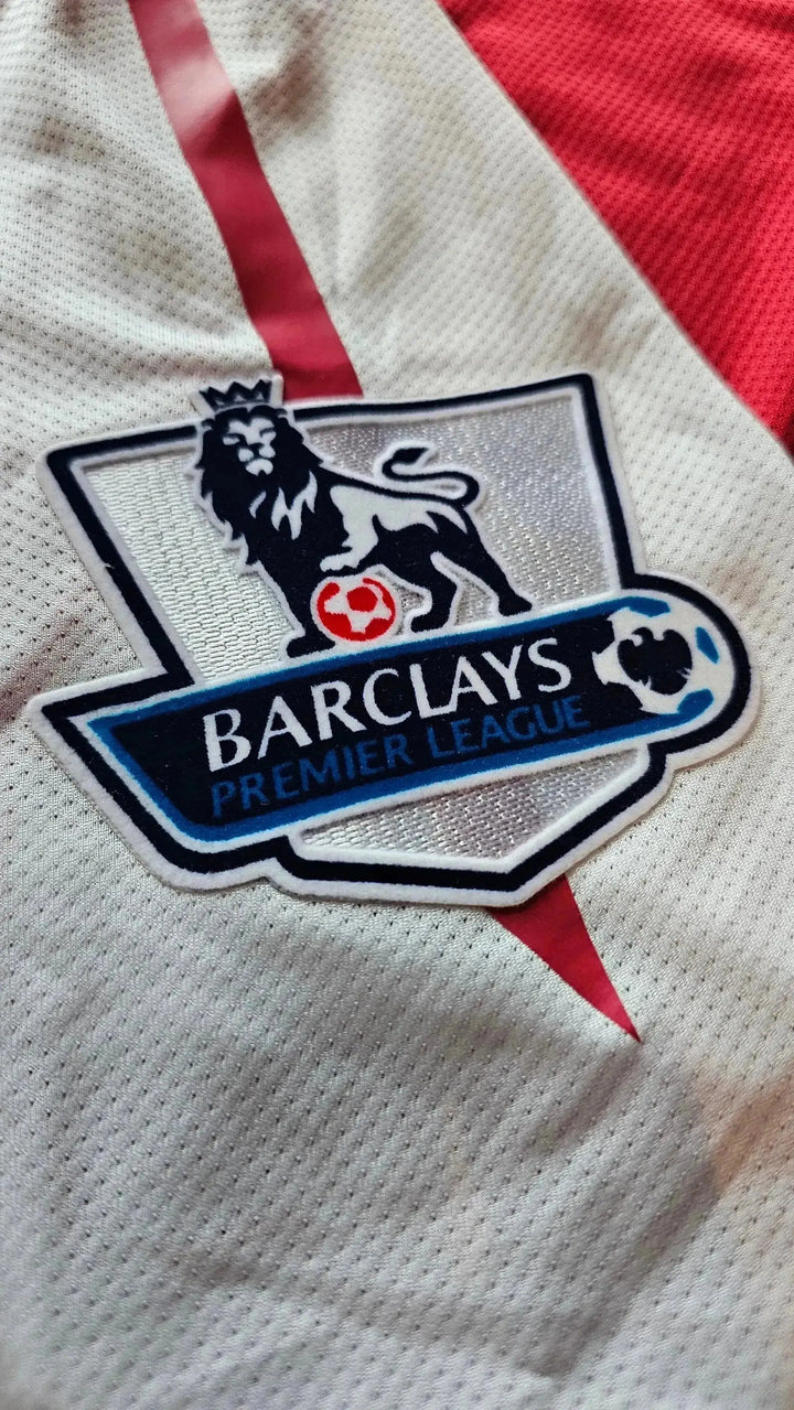 Detail of the Barclays Premier League crest on a white football shirt with red accents.