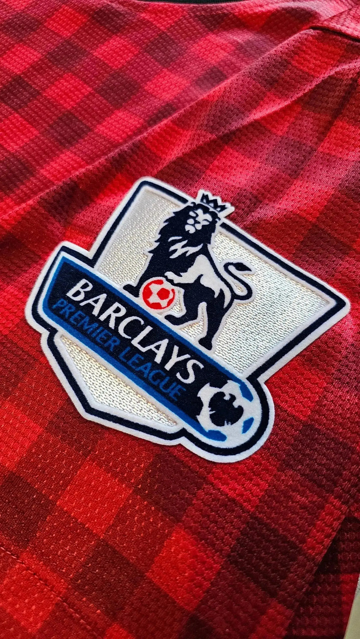 Crest detail showing the Barclays Premier League logo with a lion on a red checkered background.