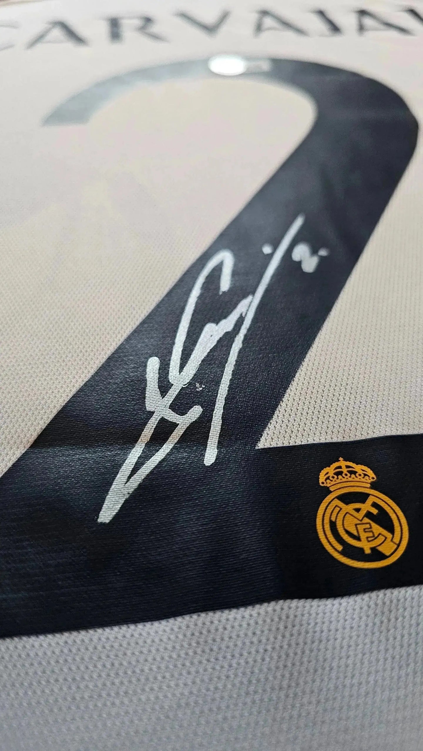 Close-up of signature and No. 2 on Dani Carvajal Signed Real Madrid Football Shirt with club crest.