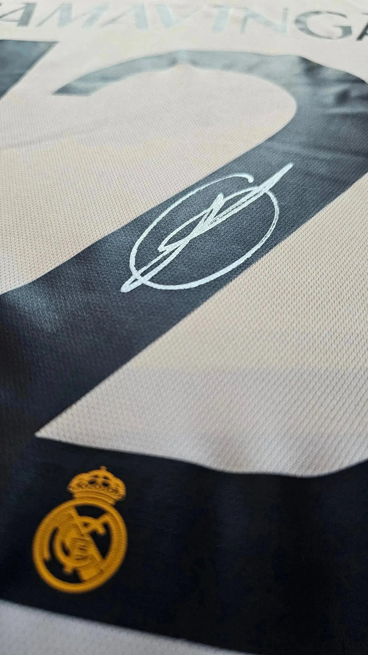 Close-up of No. 12 Camavinga with signature and Real Madrid crest detail on football shirt.