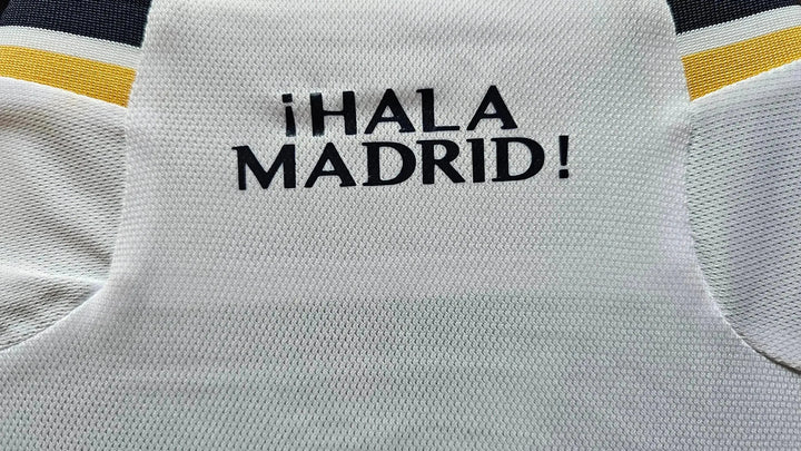Detail showing the text ¡HALA MADRID! on the back of the signed football shirt.