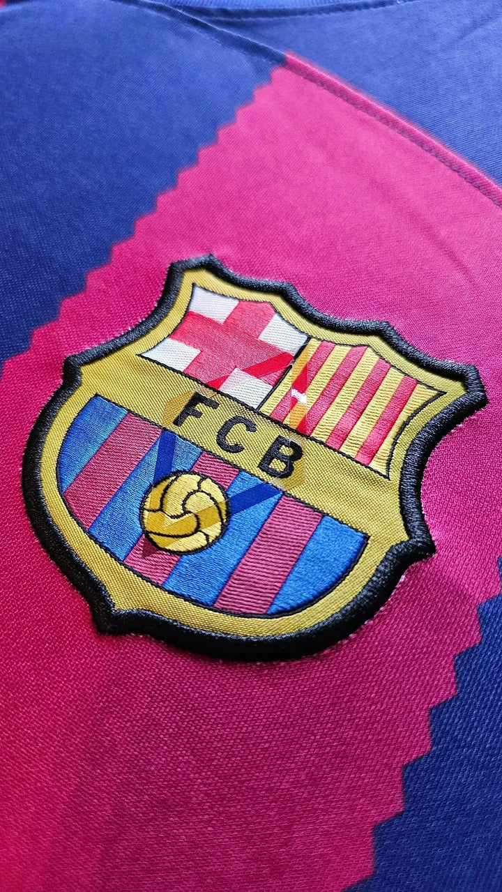 Crest detail featuring FC Barcelona emblem with red and blue vertical stripes.