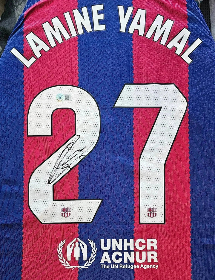 Back view featuring Lamine Yamal, No. 27, and a visible signature on the FC Barcelona shirt.