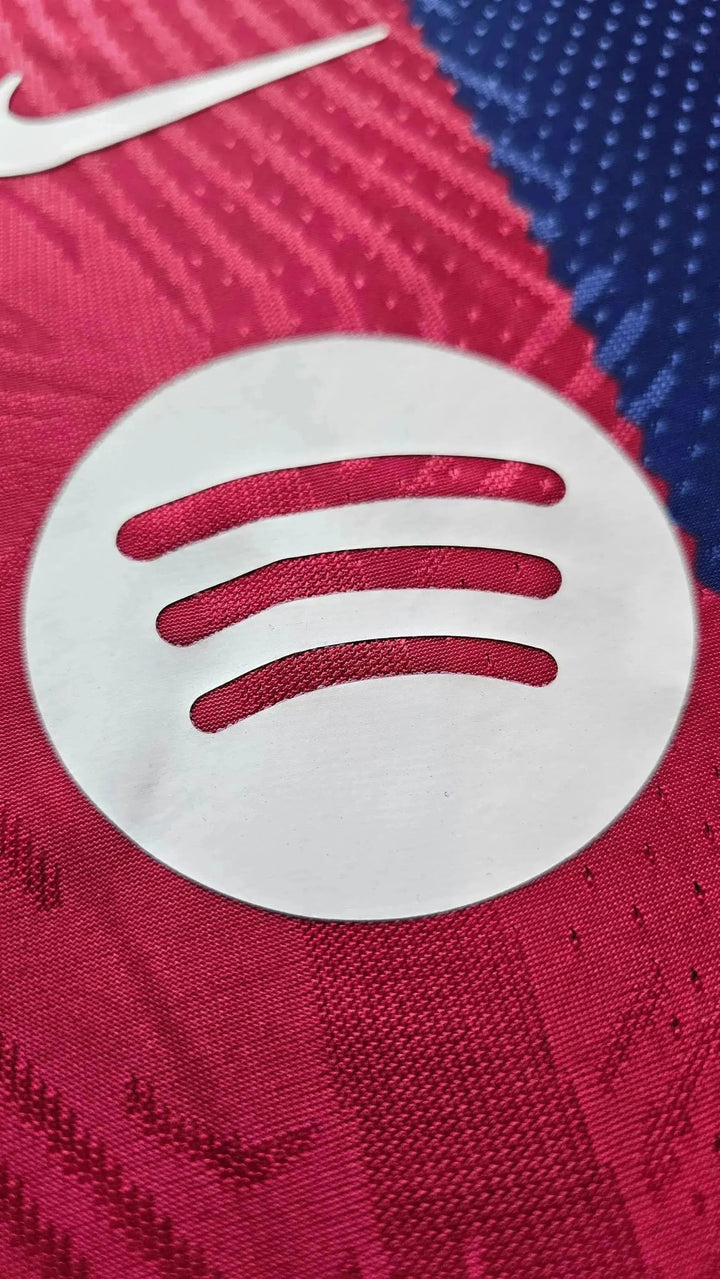 Close-up of the white Spotify icon and part of the Nike swoosh on the Lamine Yamal FC Barcelona 2023-24 home shirt.