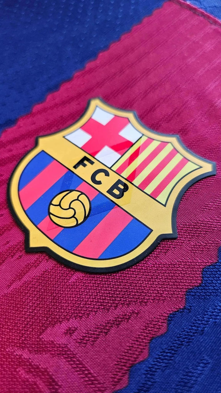Close-up of the FC Barcelona crest with FCB lettering and ball emblem on the Lamine Yamal No. 27 home shirt, 2023-24.