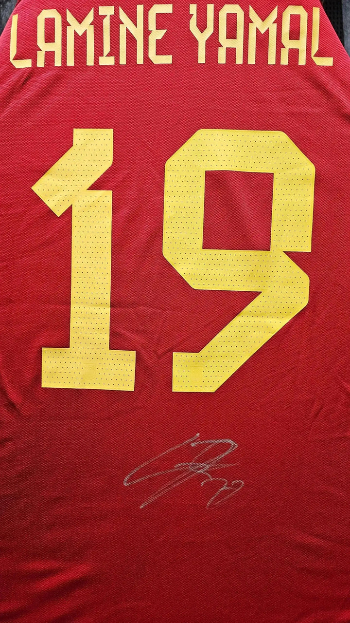 Back view showing Lamine Yamal, No. 19, and a visible signature in white ink.