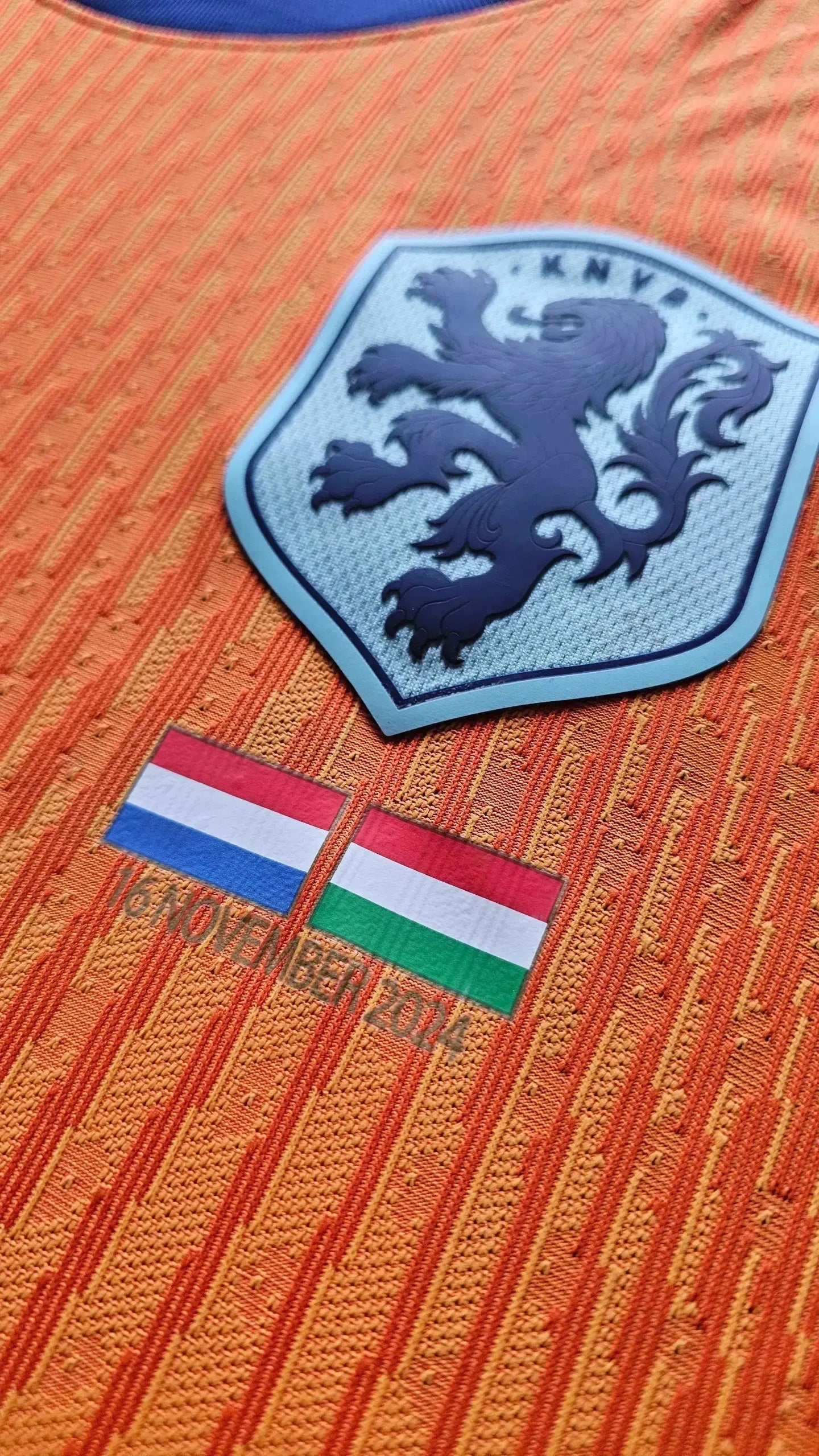 Crest detail featuring KNVB logo, match flags of Netherlands and Hungary, and date 16 NOVEMBER 2014.