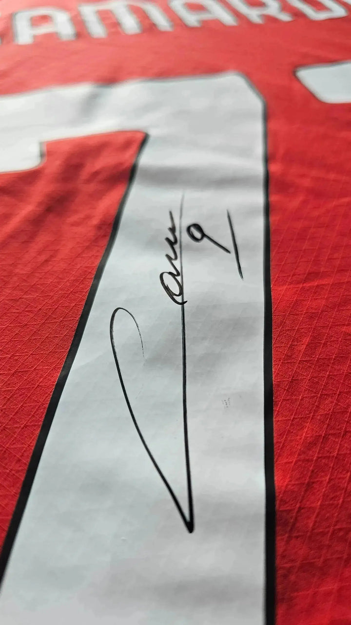 Detail showing signature of Camarda on a red football shirt with No. 73.