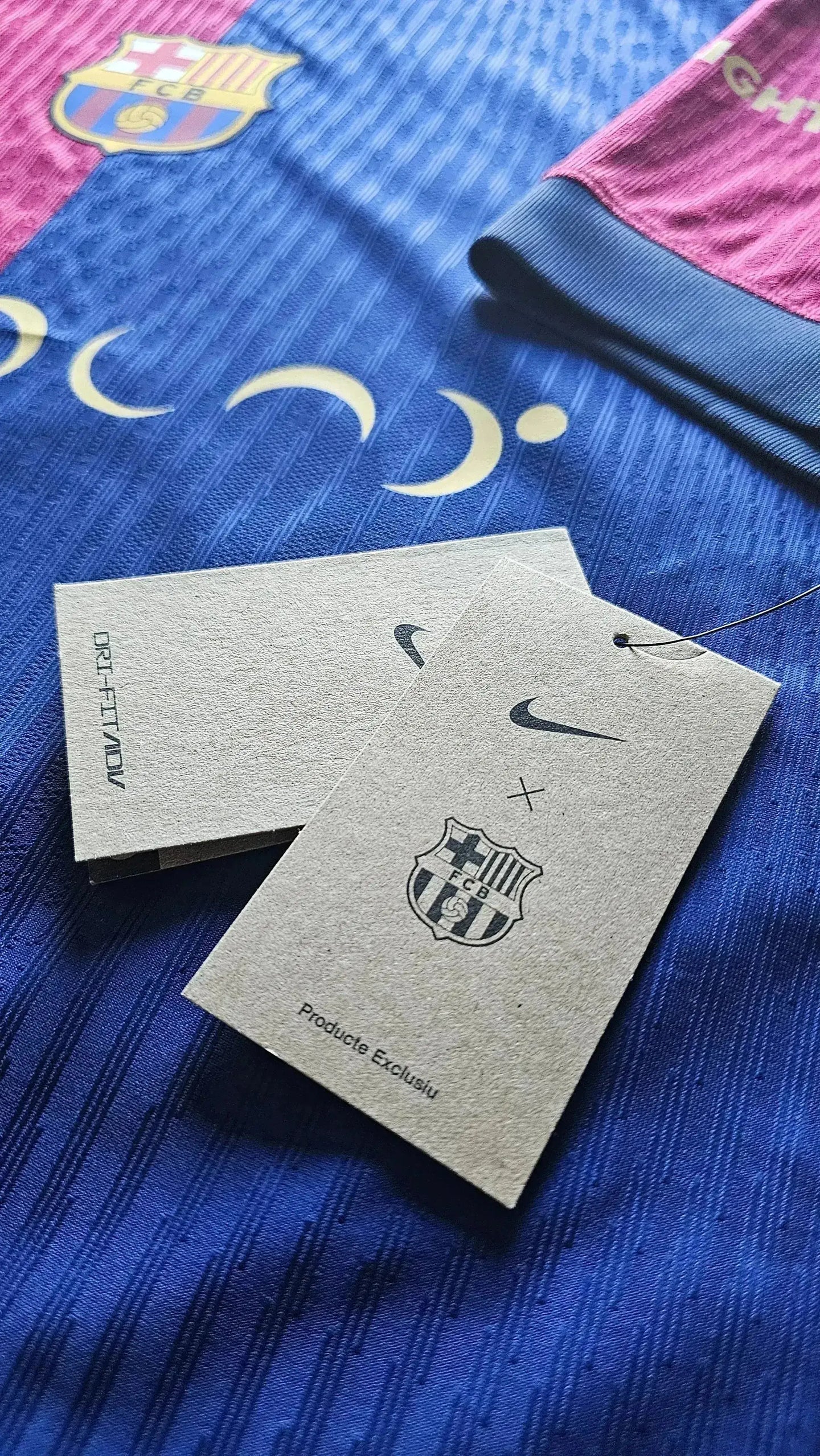 Detail view of FC Barcelona crest and Nike tags on Lamine Yamal 19 football shirt.