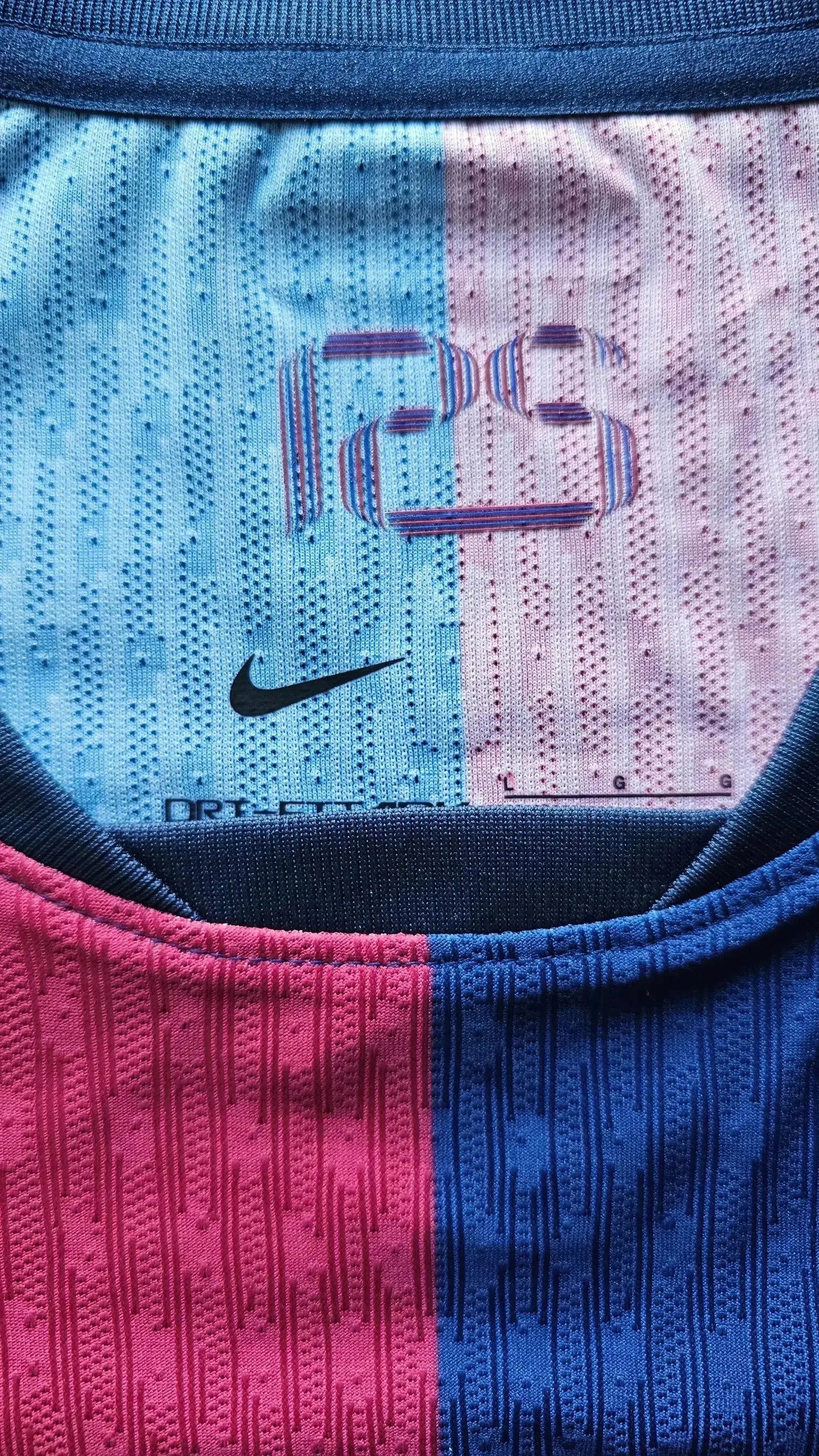 Close-up view showing Nike logo, and pink to blue gradient texture details.