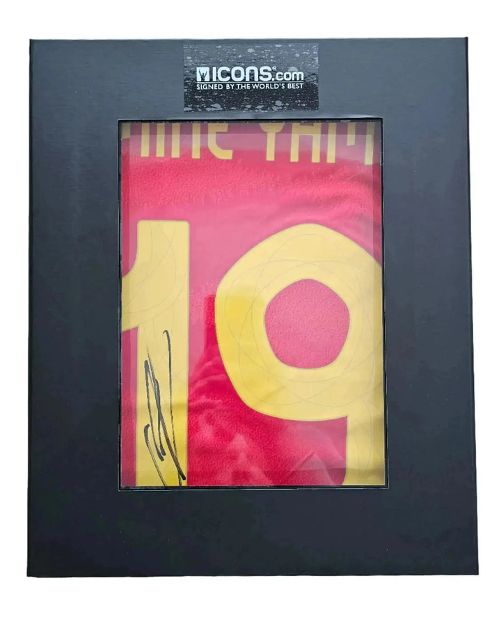 Framed view of a signed football shirt displaying No. 19 and a visible signature.
