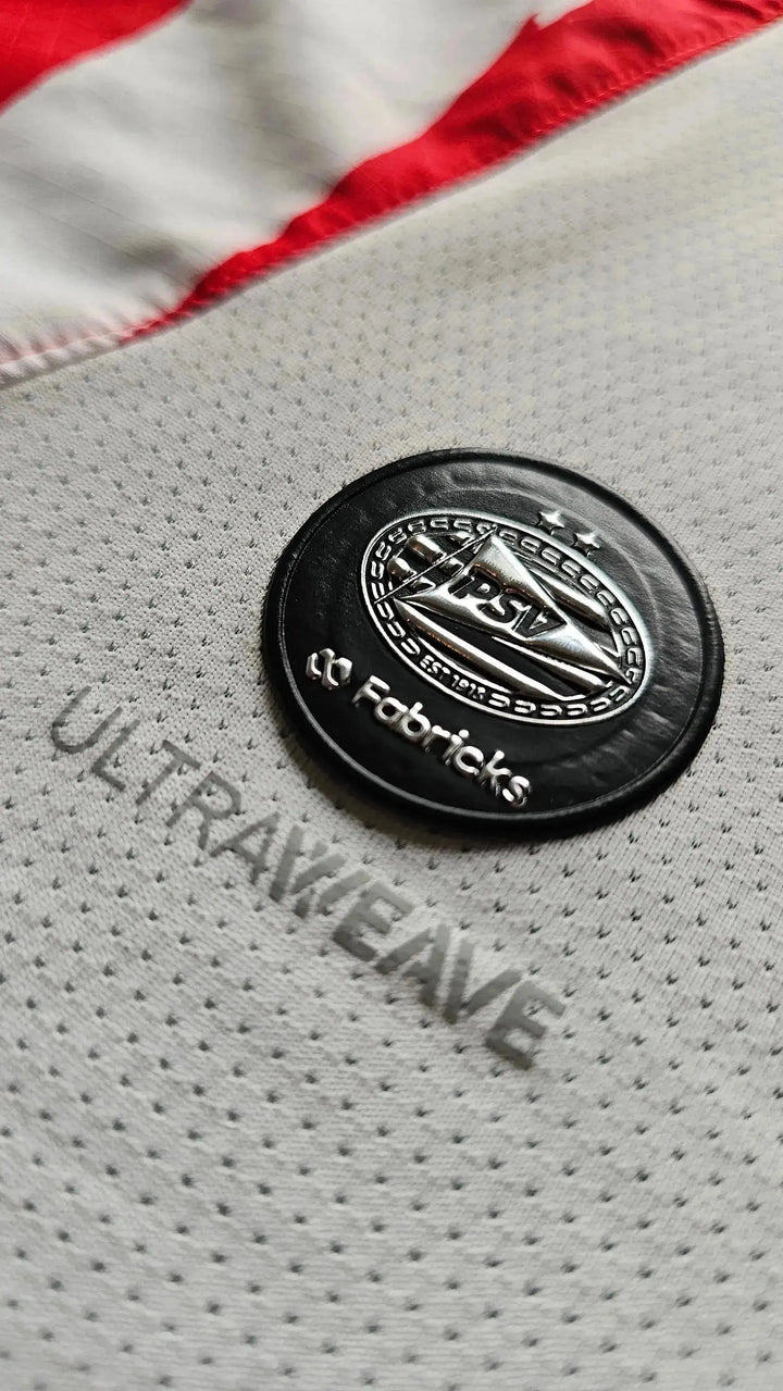 Crest detail featuring PSV logo, two stars, and &