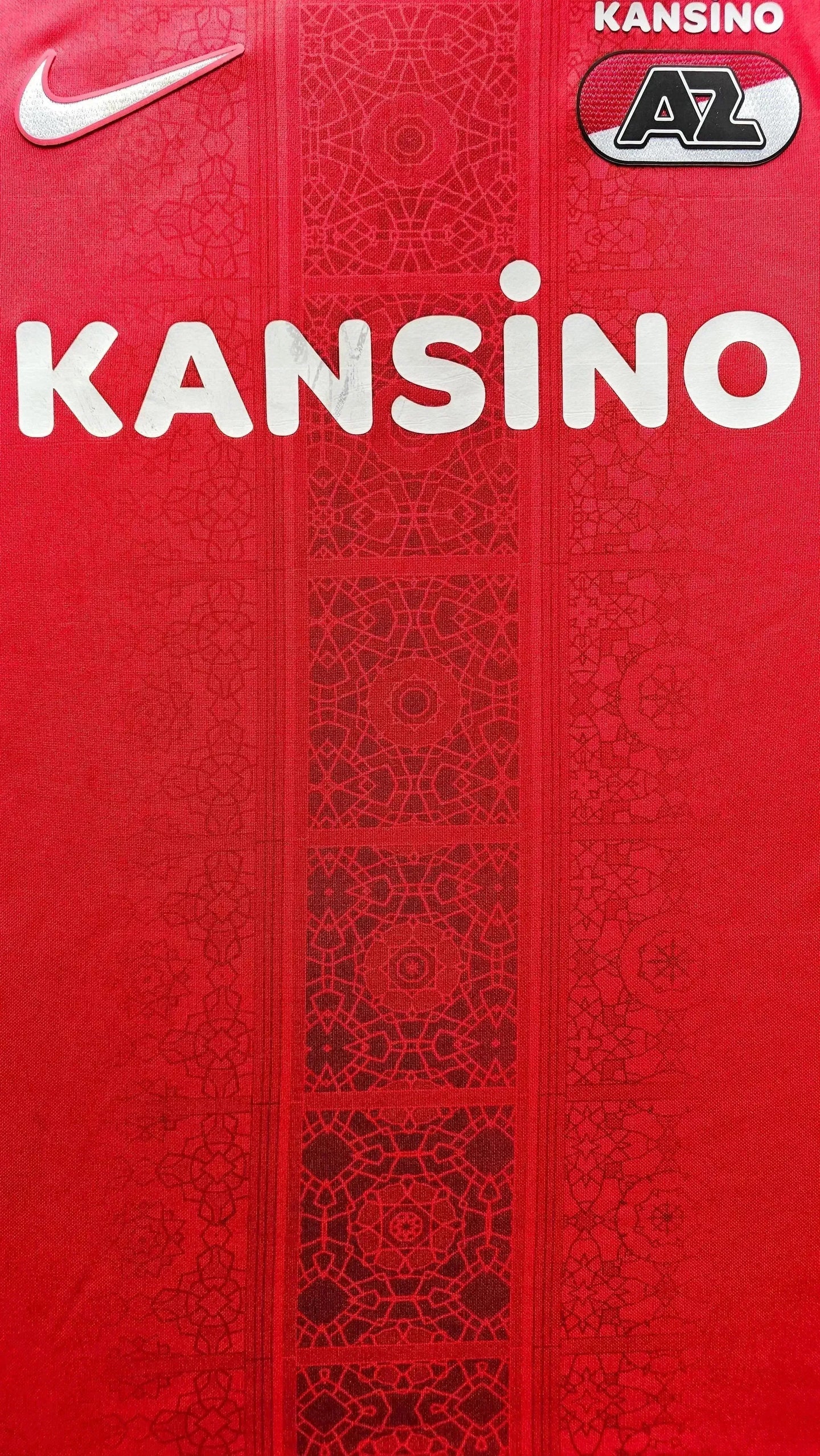 Front view showing the Nike logo and KANSINO sponsor on a red AZ Alkmaar shirt.