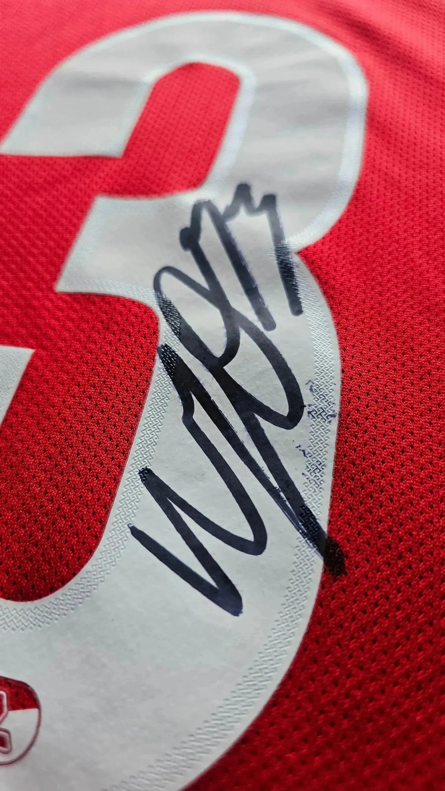 Close-up of No. 3 with Wouter Goes signature on a red football shirt.