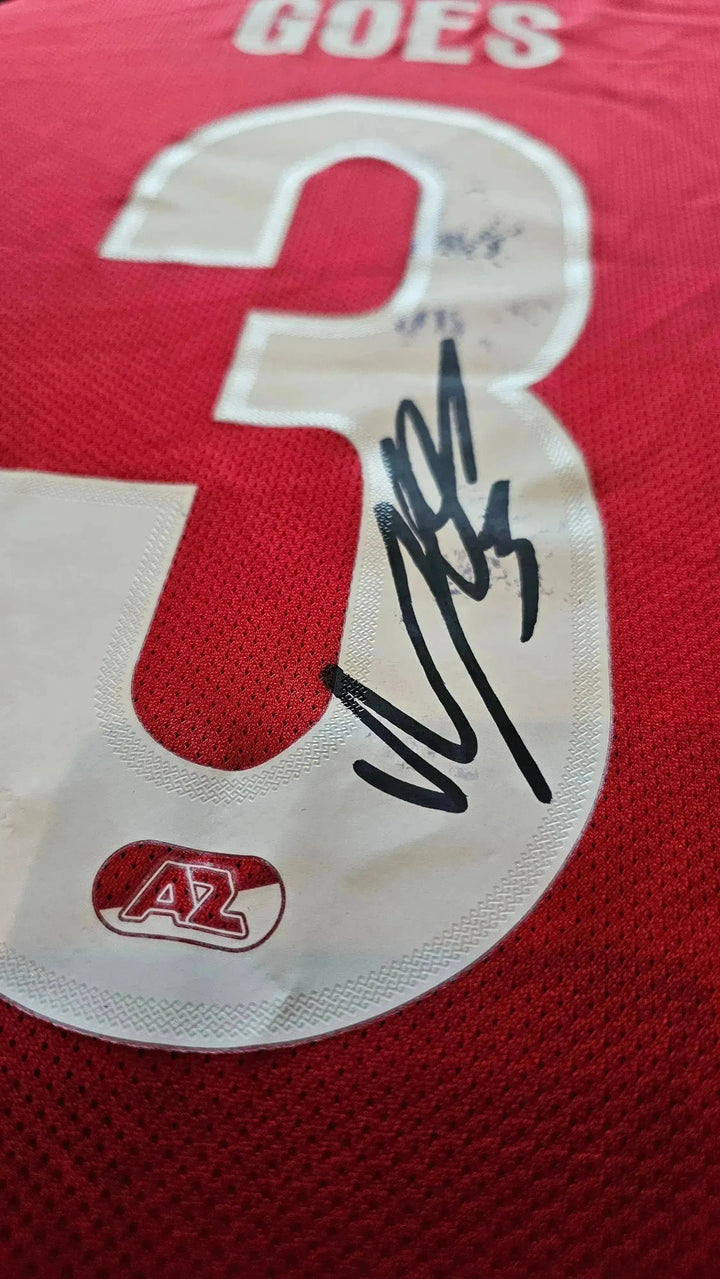 Detail showing signature and No. 3 on red AZ Alkmaar football shirt with player's name, Goes.