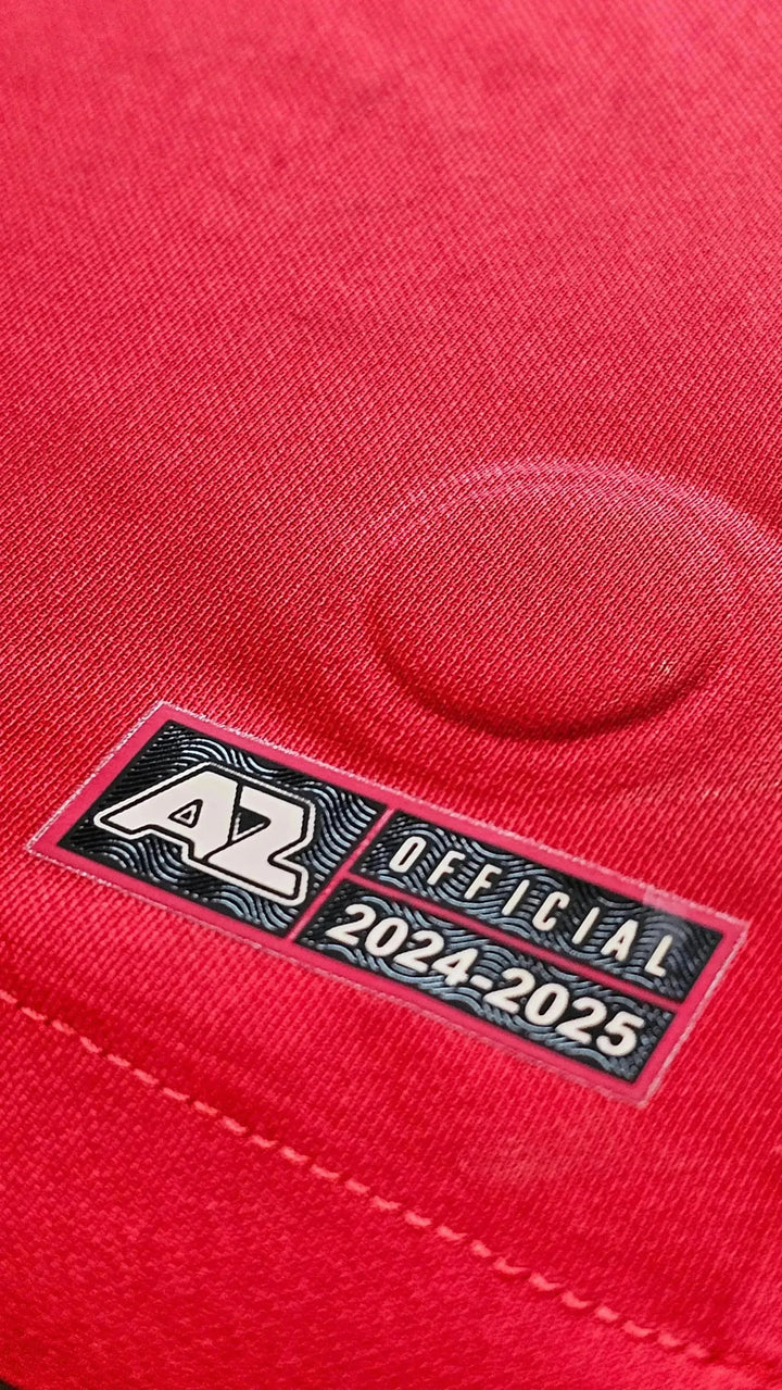 AZ official tag showing 2024-25 on a red fabric background.