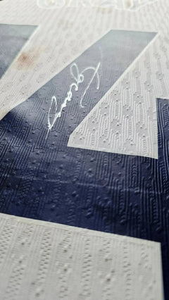 Detail view showing No. 14 and signature on the white Tottenham Hotspur football shirt.