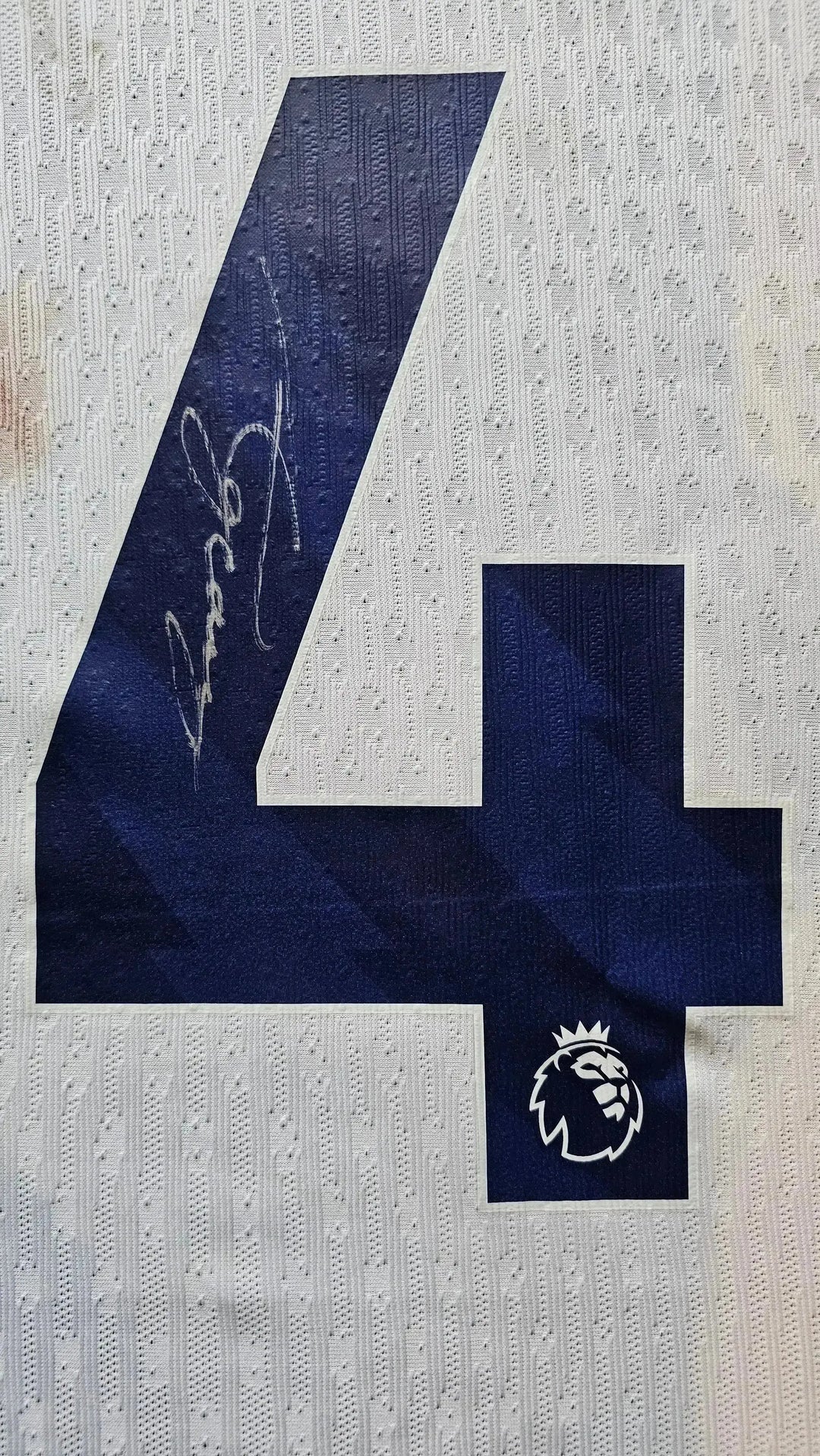 Signature detail showing No. 14 and signature on the back of the football shirt.