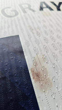 Close-up detail showing the name 'GRAY' on a signed Tottenham Hotspur football shirt.
