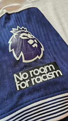 Close-up view showing the Premier League lion crest and 'No room for racism' message.