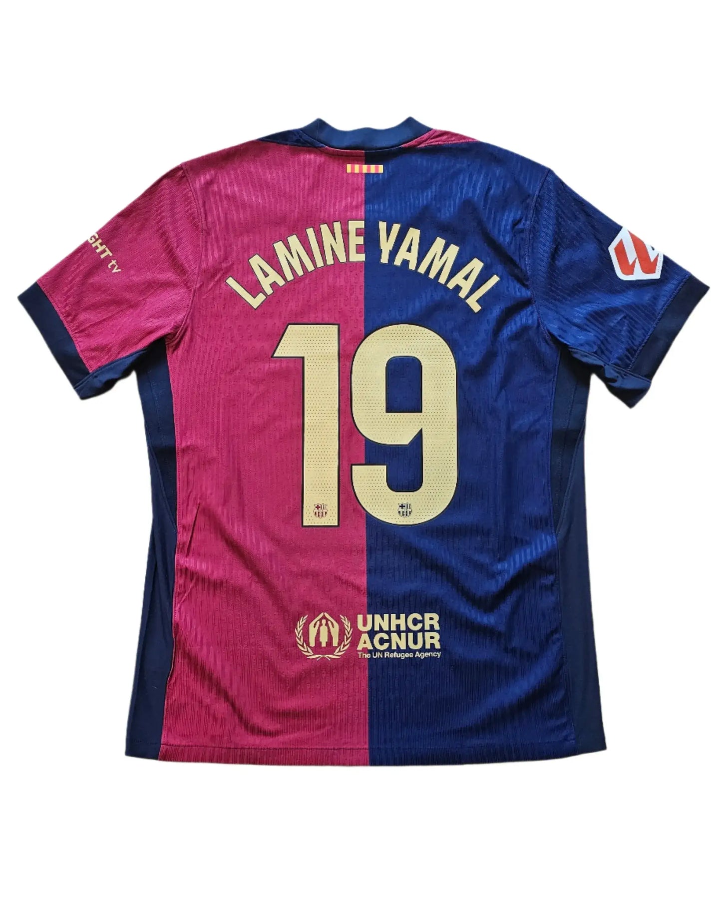 Back view of Barcelona football shirt featuring Lamine Yamal and No. 19 with UNHCR logo.