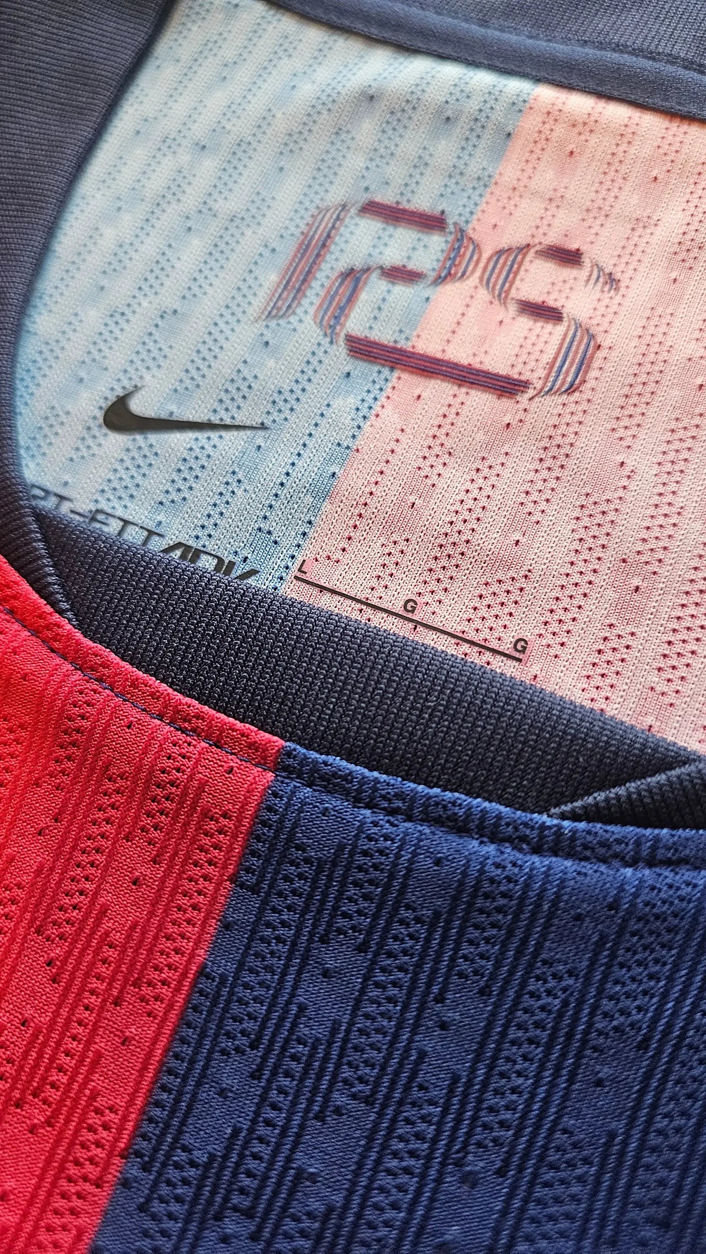 Detail view showing Nike branding on a blue and red Barcelona shirt.