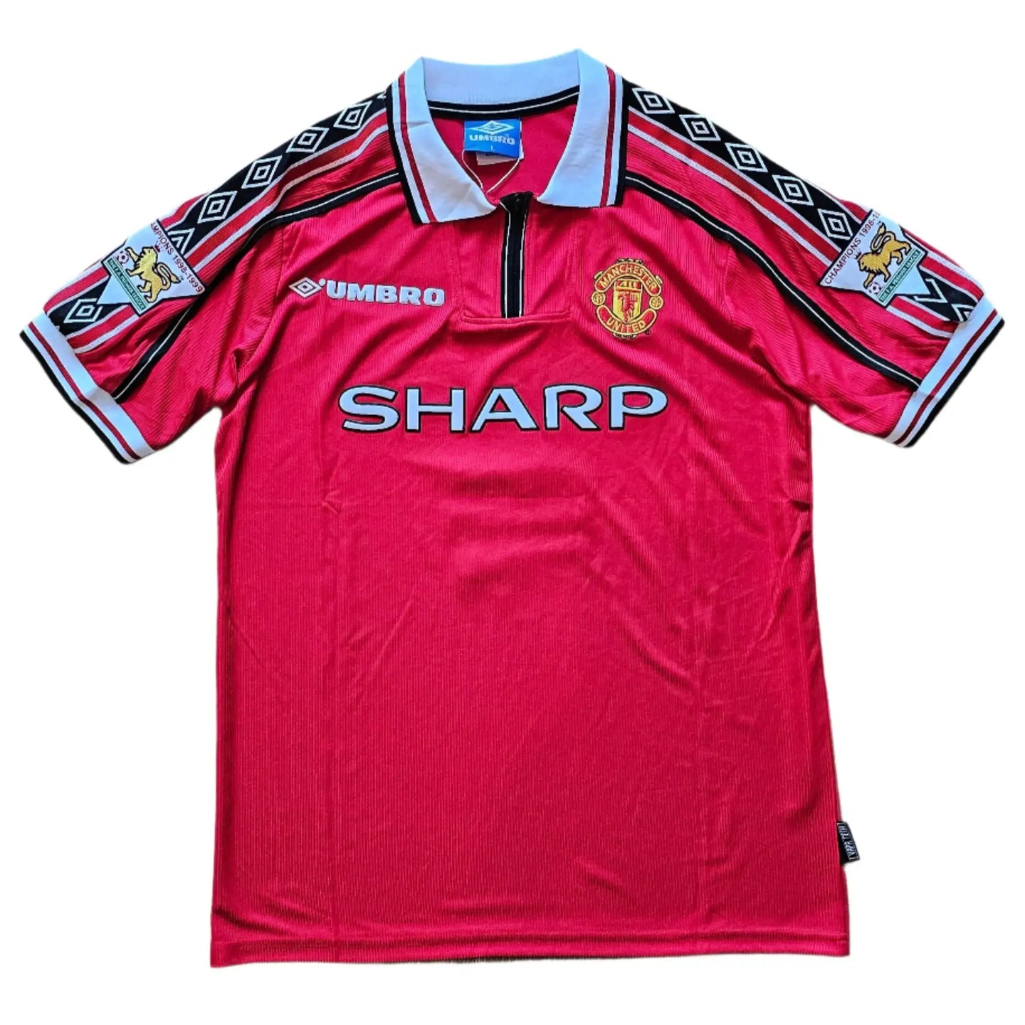 Front view of a Manchester United football shirt with emblem, sponsor 'SHARP', and Umbro logo.