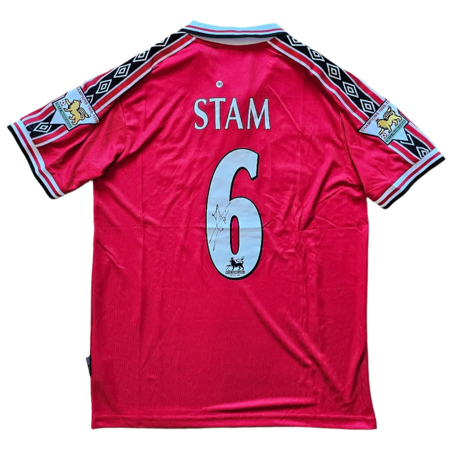 Back view displaying player name STAM, squad No. 6, and signature detail on red shirt.