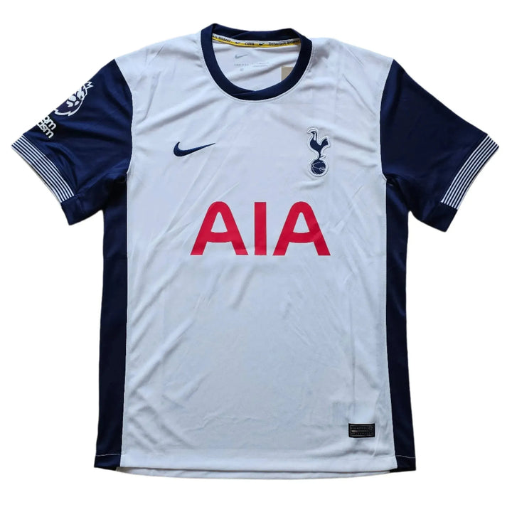 Front view of the Tottenham football shirt featuring the AIA sponsor and club crest.