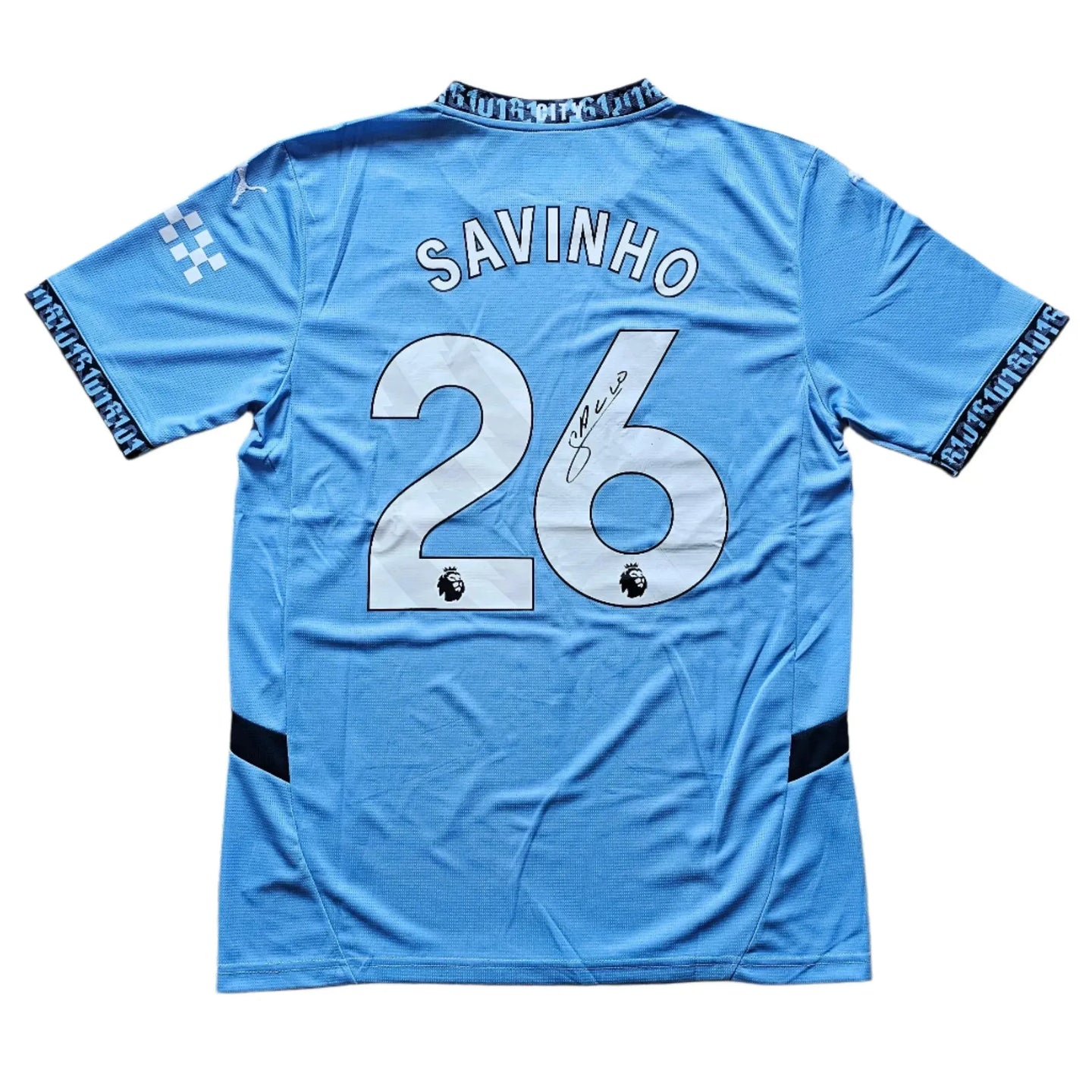 Back view featuring Savinho, No. 26, and a visible signature.