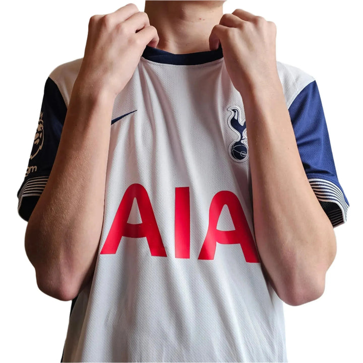 Front view of Archie Gray 14 Tottenham signed football shirt with AIA sponsor logo and club crest.
