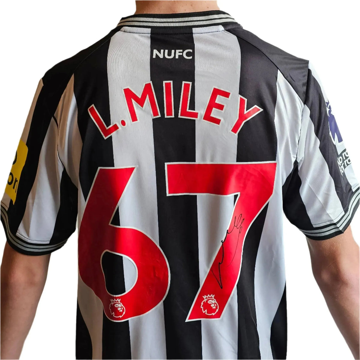 Back view featuring L. Miley, No. 67, and a visible signature on a Newcastle football shirt.