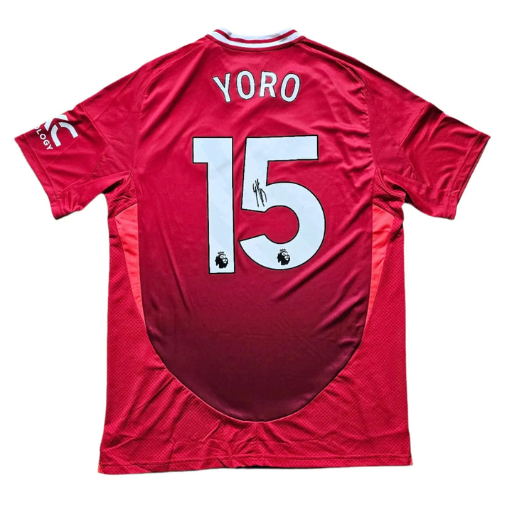 Back view showing Yoro and No. 15 with a visible signature on a red football shirt.