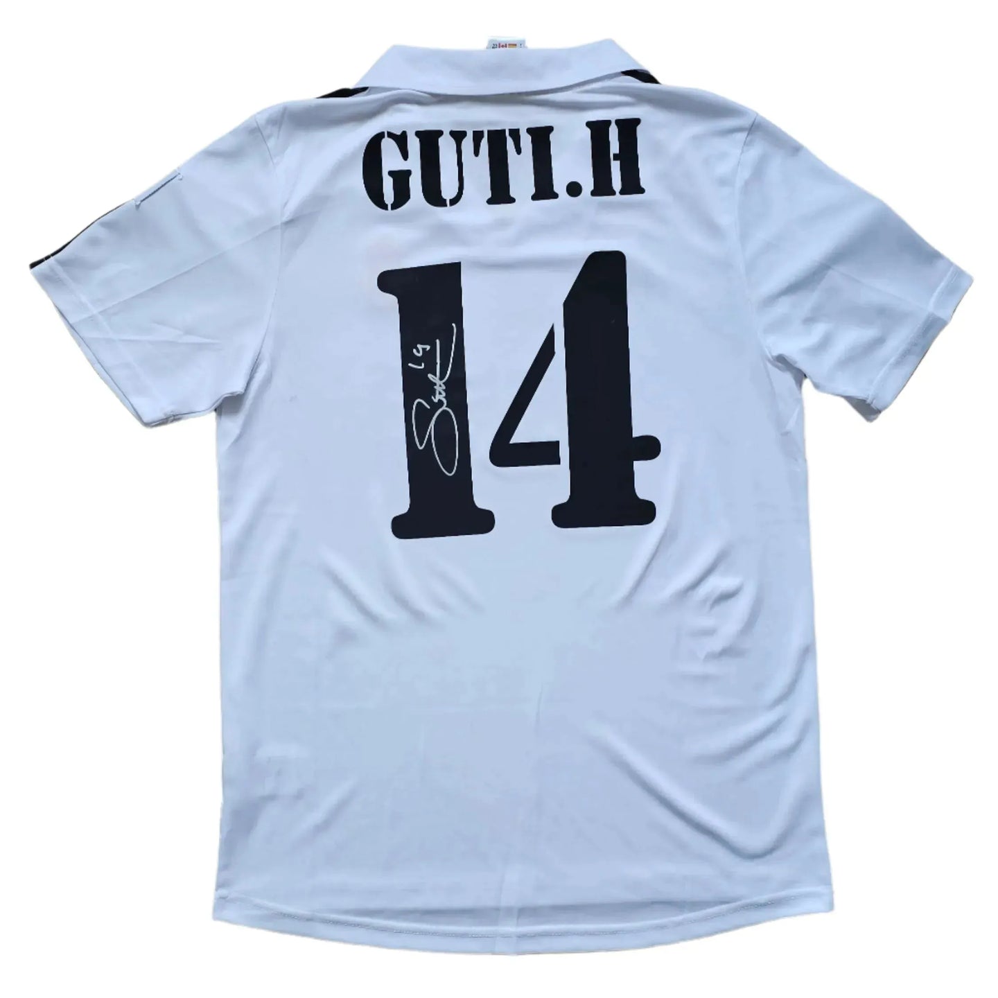 Back view of signed white football shirt with GUTI.H and No. 14 displayed prominently.