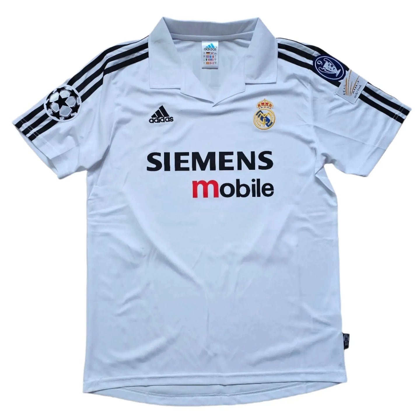 Front view of a signed Guti 14 Real Madrid football shirt with Siemens sponsor and UEFA Champions League badge.