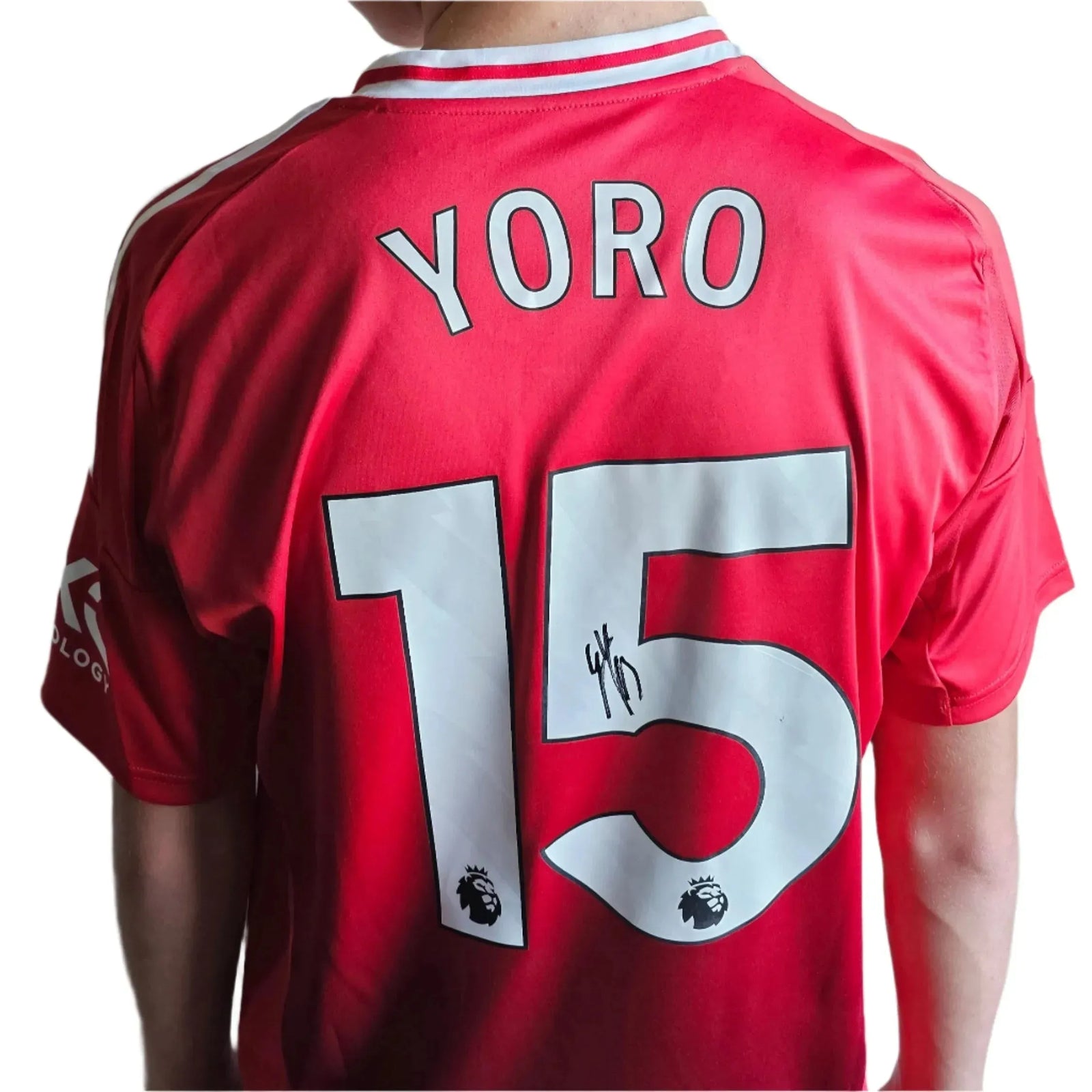 Back view showing Yoro, No. 15, and a visible signature on the red football shirt.