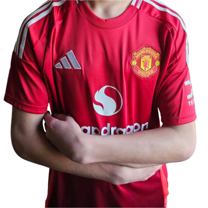 Front view of a Manchester United football shirt featuring signature detail and crest.