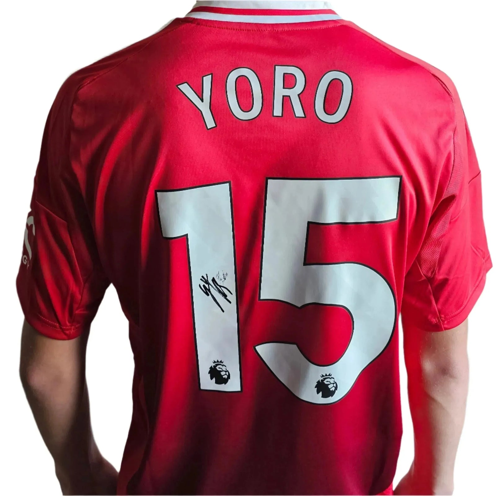 Back view showing Yoro, No. 15, and a visible signature on a red football shirt.