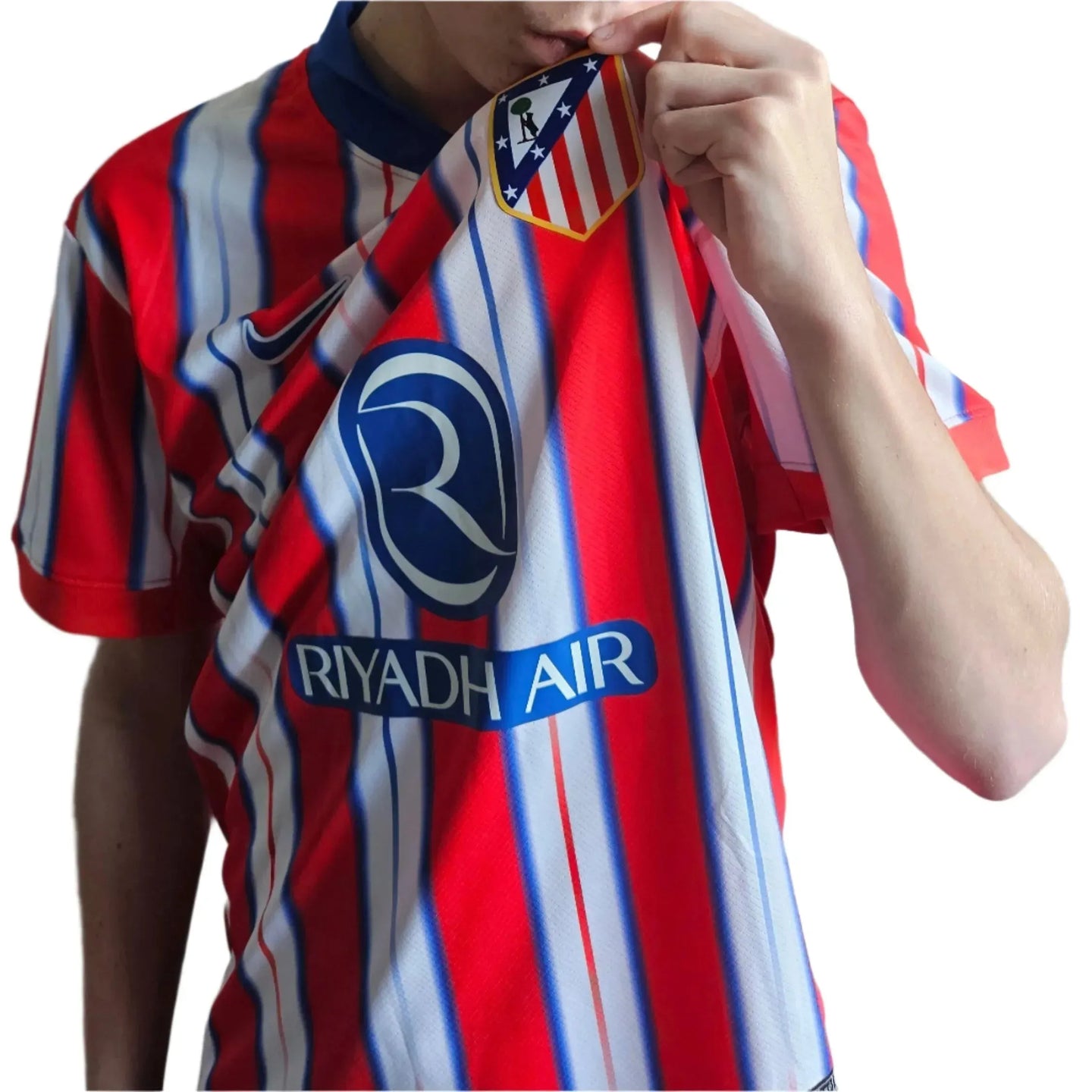 Front view of red and white striped football shirt with Atlético Madrid crest and RIYADH AIR sponsor.