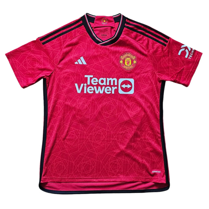 Front view of red Manchester United football shirt featuring crest and Team Viewer sponsor.